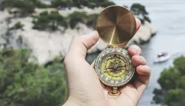 Person holding a compass