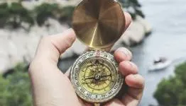 Person holding a compass